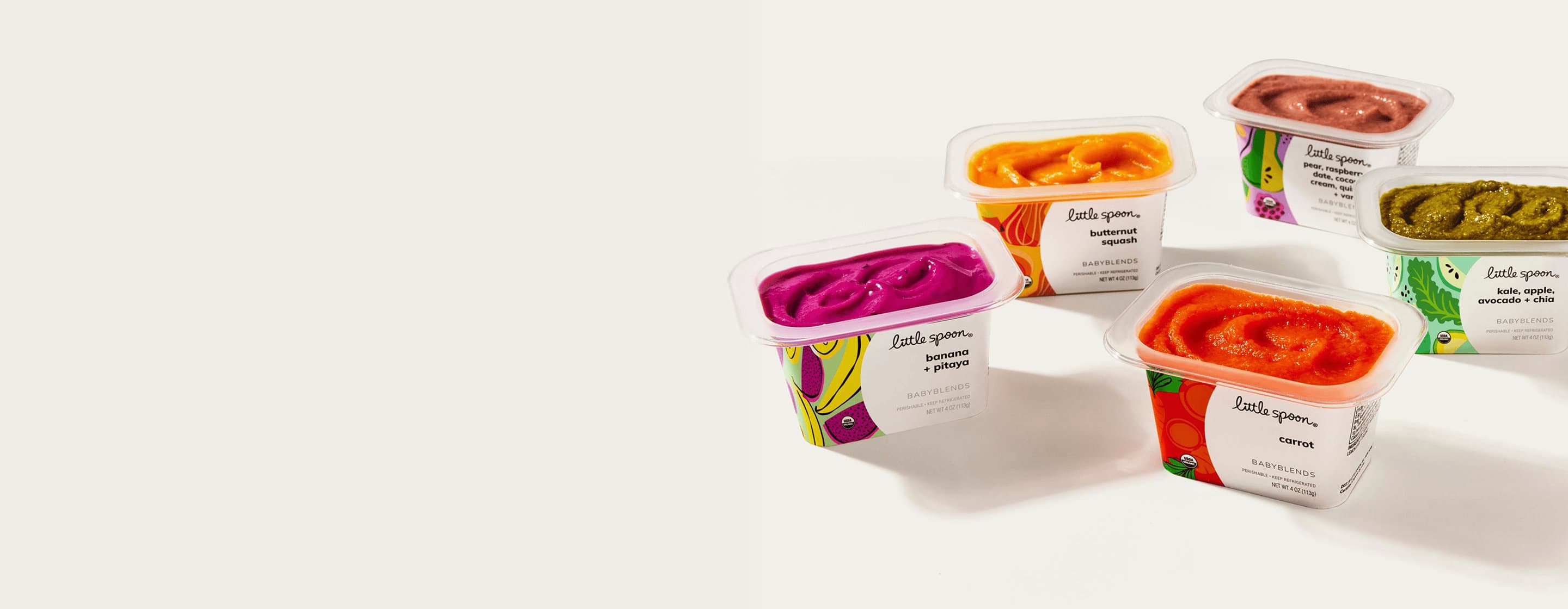 Five Little Spoon Babyblends cups in assorted flavors, including banana + pitaya, carrot, butternut squash, and kale blends.