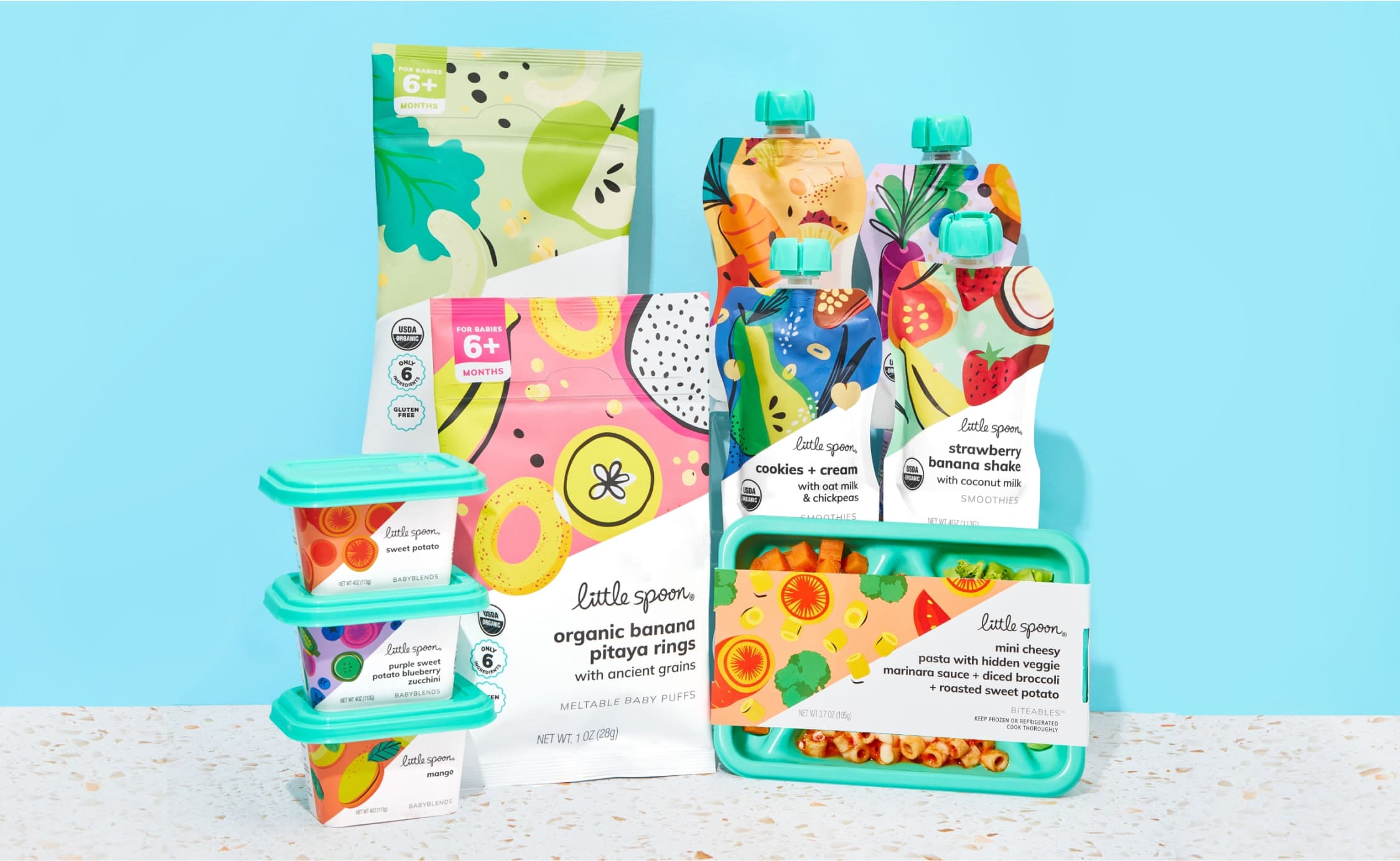 A showcase of Little Spoon products suited for babies and toddlers. Various flavors of Babyblends, Puffs, and Smoothies are shown alongside a Biteables tray.