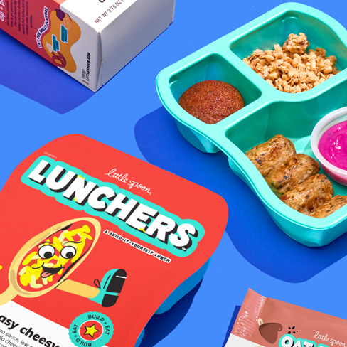 A small image of the Pizza Luncher box and an opened Chicken Dunkers Luncher. The products are on a blue background.